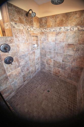 a bathroom with a shower with a tiled floor at The Inn at Thunder Mountain in Sedona