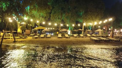 a group of tables and chairs on a beach at night at Marimare Beach & Bungalow in Marmaris