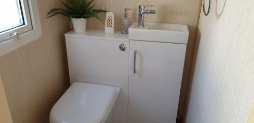 a small bathroom with a toilet and a sink at C28 Angels retreat in Par
