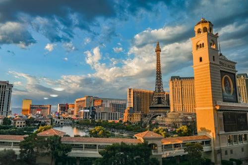 a view of a city with the eiffel tower at StripViewSuites at Jockey Club in Las Vegas