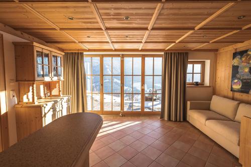 a living room with a couch and a table at Chalet Obenland Panorama Aussicht Kitzbühler Alpen in Bramberg am Wildkogel