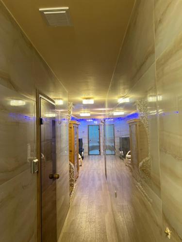 a hallway in a building with a door and a room at Safi in Dospat