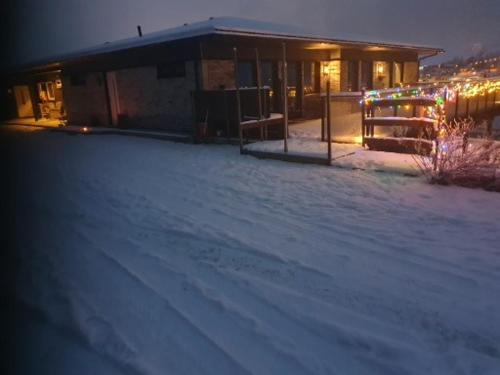 a building with snow on the ground in front of it at Olden Panorama Apartments - Fjord view - High Standard in Olden
