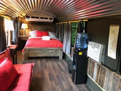 a bedroom in a train with a bed and a couch at Canal Cabins in Paw Paw