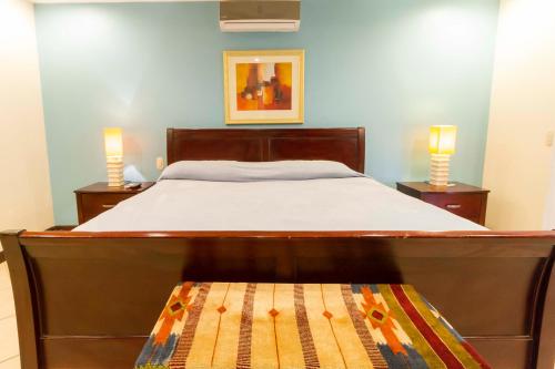 a bedroom with a large bed with two night stands at Monte Carlo Luxury Condominiums in Jacó