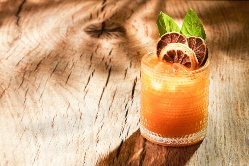 a drink with oranges and grapefruit on a wooden table at Mondrian Los Angeles in Los Angeles