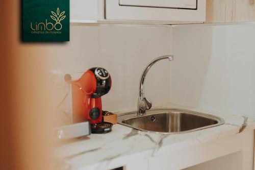 a kitchen counter with a sink and a mixer at Limbo Cabañas de Malpica in Malpica
