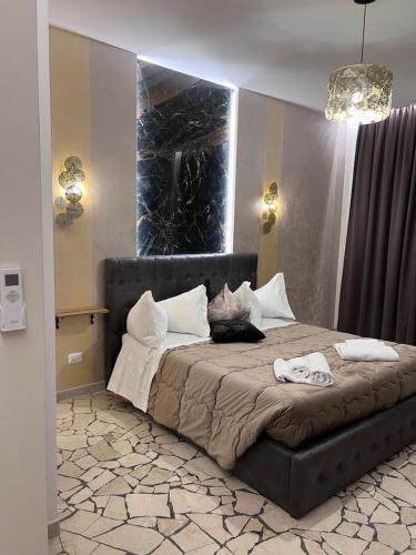 a bedroom with a large bed with a large window at Residenza N&D Luxury in Bari