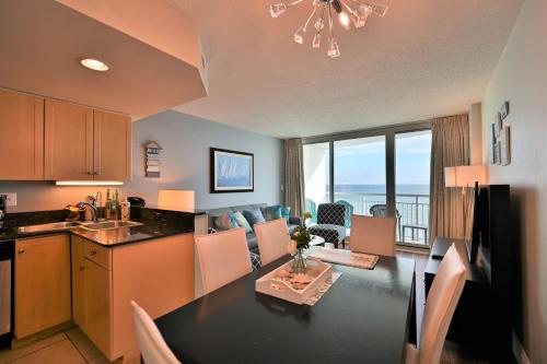 a kitchen and living room with a table and a dining room at Luxury 2 bedroom 2 bathroom Ocean Front Condo on the 12th floor for 8 in Myrtle Beach