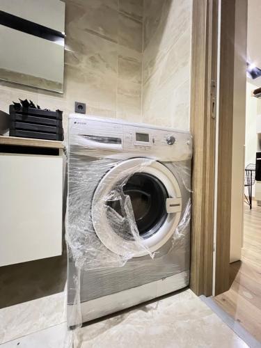 a washing machine wrapped in plastic in a kitchen at City centre Apartment in Esenyurt