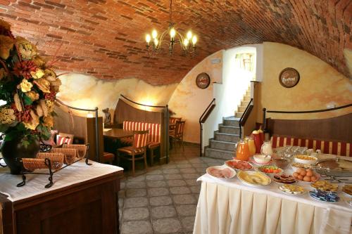 a dining room with a table with food on it at Hotel v Centru in České Budějovice