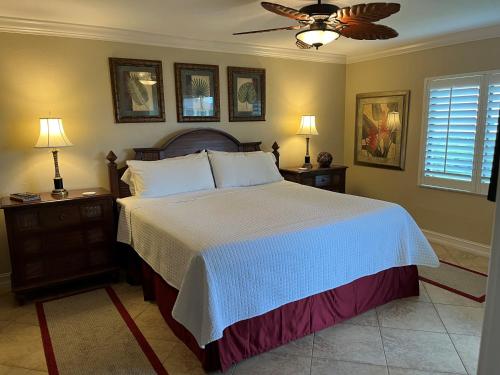a bedroom with a large bed with two nightstands and two lamps at SANDPIPER BEACH 205 in Sanibel