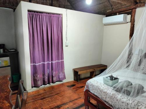 Cama ou camas em um quarto em Villa Akbal