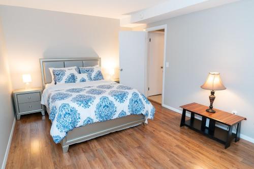 a bedroom with a bed and a table with a lamp at Beautiful Space all for you! in New Britain