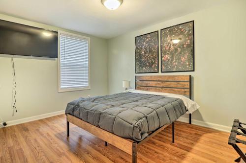 a bedroom with a bed and a large window at Charming Warwick Vacation Rental Walk to Bay in Warwick