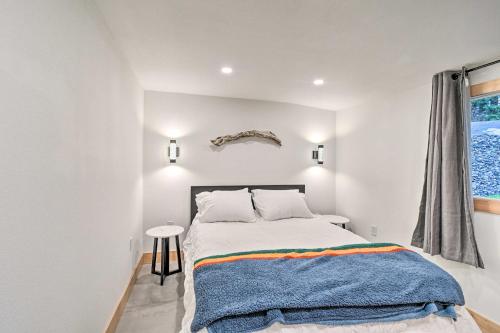 a white bedroom with a bed and a window at Dreamy Bayfront Cabin with View, Dock and Kayaks in Olympia
