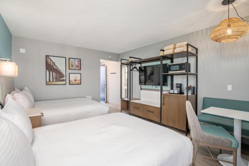 a hotel room with two beds and a desk at Shoreline Inn...on the beach in Cayucos
