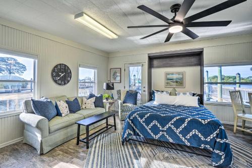 a bedroom with a bed and a couch and a clock at Waterfront Tarpon Springs Vacation Rental! in Tarpon Springs