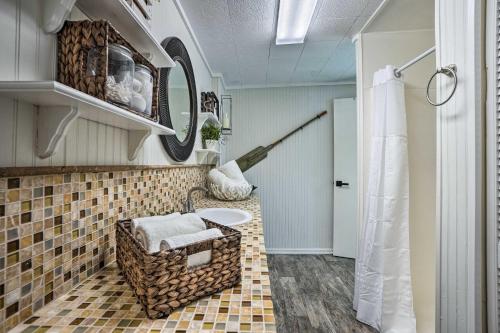 a bathroom with a sink and a mirror at Waterfront Tarpon Springs Vacation Rental! in Tarpon Springs