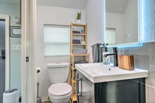 a small bathroom with a toilet and a sink at Bright Texas Cottage Near San Antonio Zoo! in San Antonio