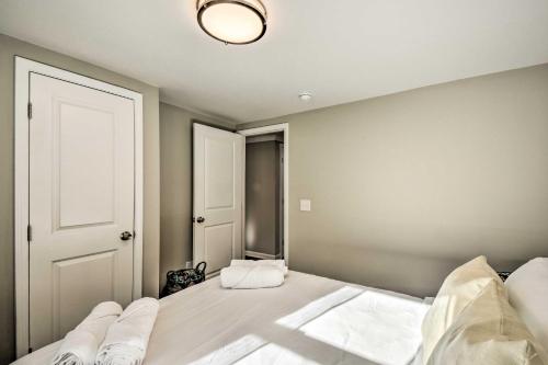 a bedroom with a large bed with a light fixture at Private Yard and Fire Pit Commerce Home! in Commerce