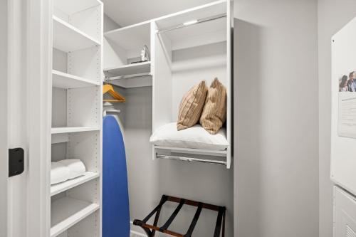 a walk in closet with a blue surfboard in it at Coda on Half, a Placemakr Experience - Navy Yard in Washington
