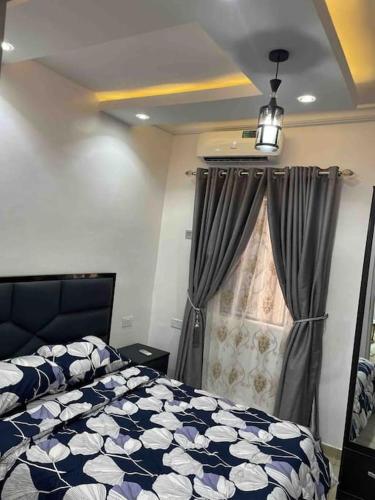 a bedroom with a bed and a window at GS HOMES in Lagos