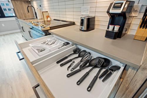 an open drawer in a kitchen with utensils at Coda on Half, a Placemakr Experience - Navy Yard in Washington