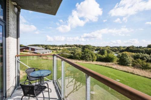 a balcony with two chairs and a view of the countryside at Best Western Plus Hotel Fredericia in Fredericia
