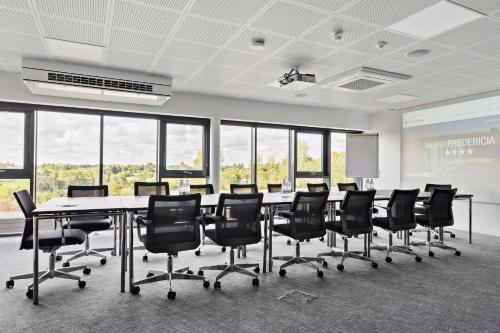 a conference room with a long table and chairs at Best Western Plus Hotel Fredericia in Fredericia