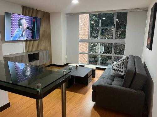 sala de estar con sofá y mesa de cristal en Apartamento en Medellín, laureles, en Medellín