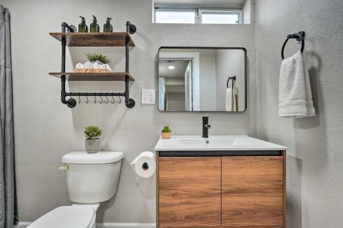 a bathroom with a sink and a toilet and a mirror at Phoenix Vacation Rental Home - Pet Friendly! in Phoenix