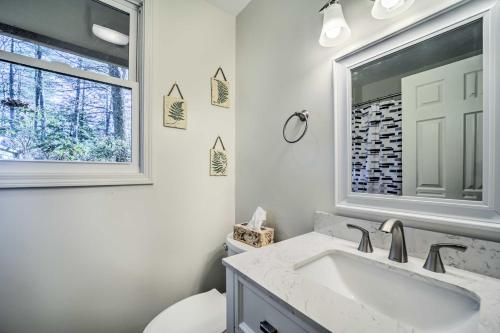 een witte badkamer met een wastafel en een raam bij Sapphire Home with Grill and Pool Access in Sapphire
