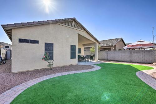 a house with a green lawn in front of it at Sunlit Peoria Gem with Yard Hike, Golf and Explore! in Peoria