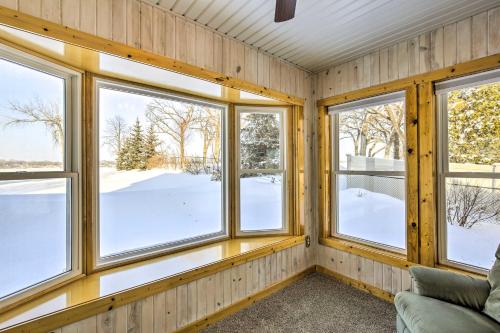 a room with four windows and a couch at Stunning Waterville Home on Tetonka Lake! in Waterville