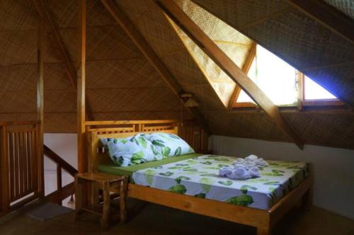 a bedroom with a bed in a attic at Hotel Renate in Panglao