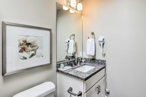 a bathroom with a sink and a mirror at Ocean Shores House with Hot Tub - Walk to Beach in Ocean Shores