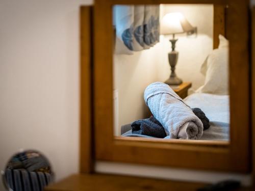 a towel laying on a bed in front of a mirror at Grayrigg Foot Stable in Grayrigg