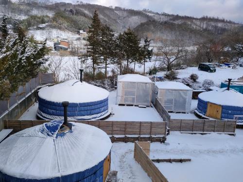 a group of domes are covered in snow at Family Hotel Matsumoto Satoyama Doors in Matsumoto