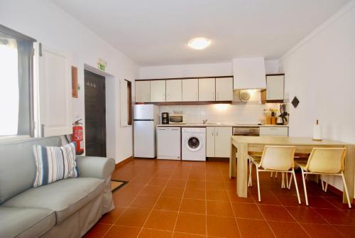 a kitchen and living room with a table and a couch at Apartamento Isabela - Baleal Island, 50m to the beach in Baleal