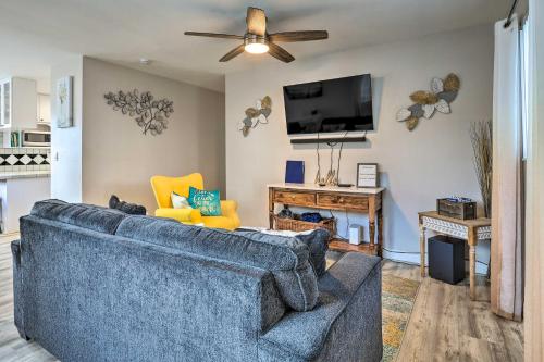 a living room with a blue couch and a flat screen tv at Gated Southern Miami Home 22 Mi to Downtown! in Miami
