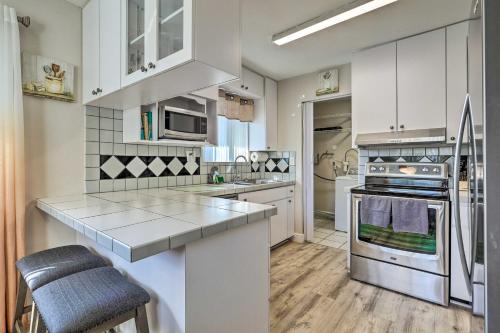 a kitchen with white cabinets and stainless steel appliances at Gated Southern Miami Home 22 Mi to Downtown! in Miami