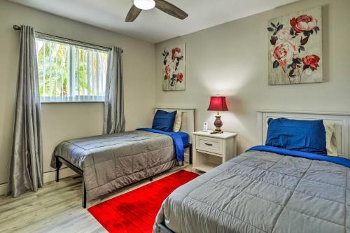 a bedroom with two beds and a red rug at Gated Southern Miami Home 22 Mi to Downtown! in Miami