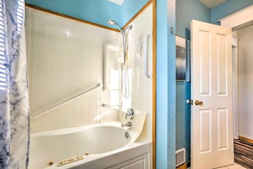 a bathroom with a tub and a shower at Fire Pit and Bay Views North Bend Home! in North Bend