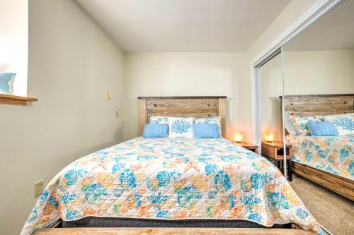 a bedroom with a bed and a mirror at Fire Pit and Bay Views North Bend Home! in North Bend