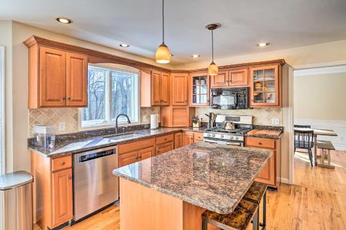 a kitchen with wooden cabinets and a granite counter top at Pet-Friendly Beacon Area Vacation Rental 6 Acres in Lagrangeville