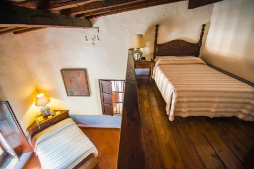 a bedroom with a large bed and a window at Meson del Alferez Xalapa in Xalapa