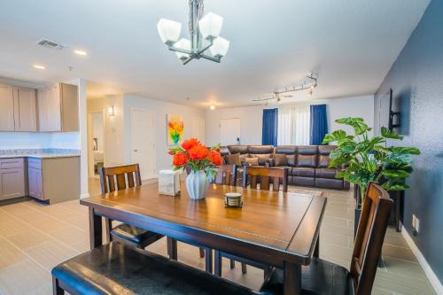 a dining room and living room with a table and chairs at Rio Del Sol Inn Needles in Needles
