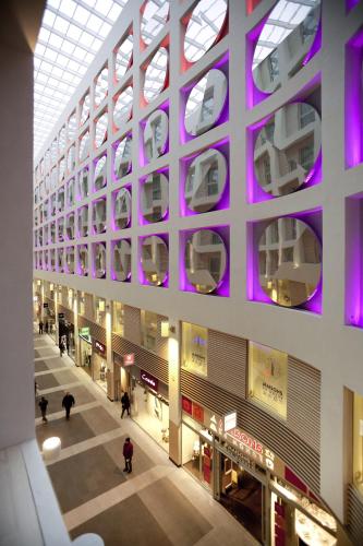 a building with purple lights on the side of it at Aparthotel Adagio Brussels Grand Place in Brussels