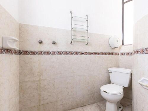 a bathroom with a white toilet and a shower at Desarrollo Turistico in Oaxtepec